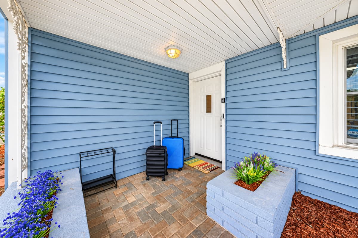 Covered front entry area with seating space and a welcoming feel for guests arriving 