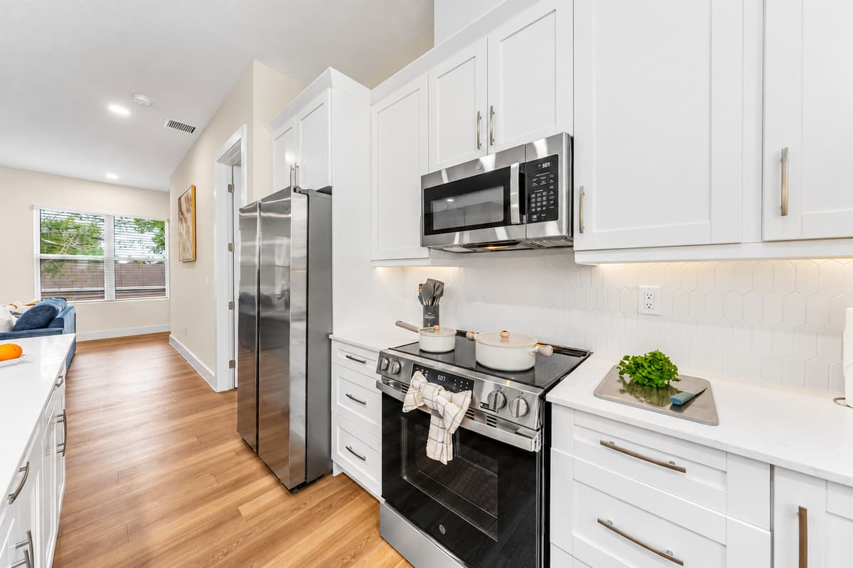 Contemporary kitchen with stainless steel appliances and bright, inviting design.