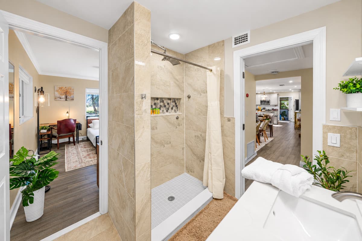 Enjoy a bright and spacious bathroom featuring a sleek vanity, contemporary fixtures, and a clean, calming aesthetic.