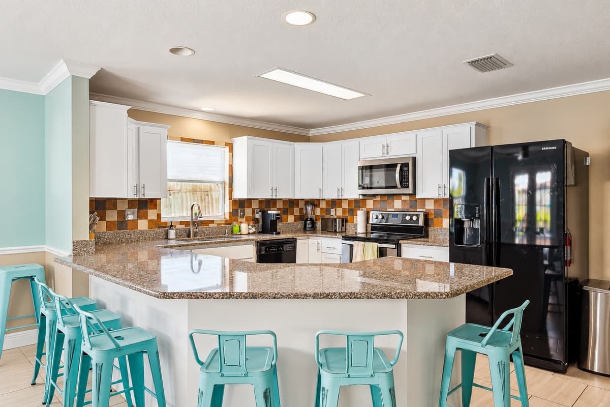 Kitchen with plenty of supplies and chairs for seating for the family