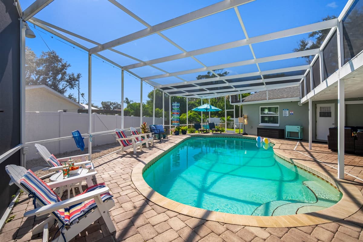 This screened-in pool deck brings resort vibes home, complete with lounge chairs, a shaded umbrella area, and plenty of space to enjoy Florida’s endless summer.