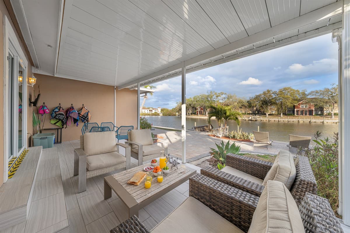 Relax on the covered waterfront patio with comfortable outdoor seating and beautiful lake views.