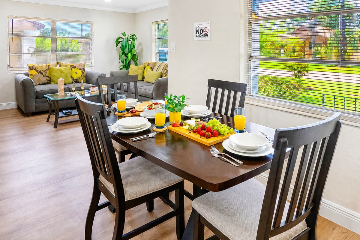 Nestled beside a large window that overlooks the front yard, the dining area is flooded with natural light, offering a warm and welcoming space to start or end your day.