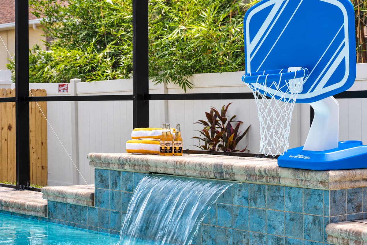 With a crystal-clear pool, waterfall feature, and basketball hoop, this space is perfect for both relaxation and family-friendly fun.