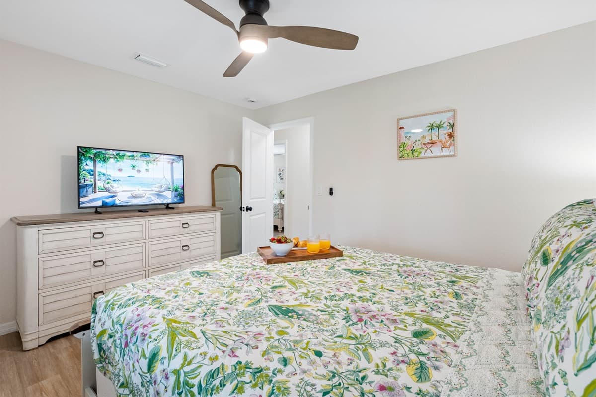 Enjoy a quiet, comfortable night in this relaxing bedroom, complete with plantation shutters and calming green accents.