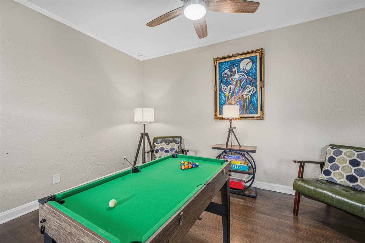 Dedicated game room with pool table and cozy seating for fun, entertainment, and friendly competition.