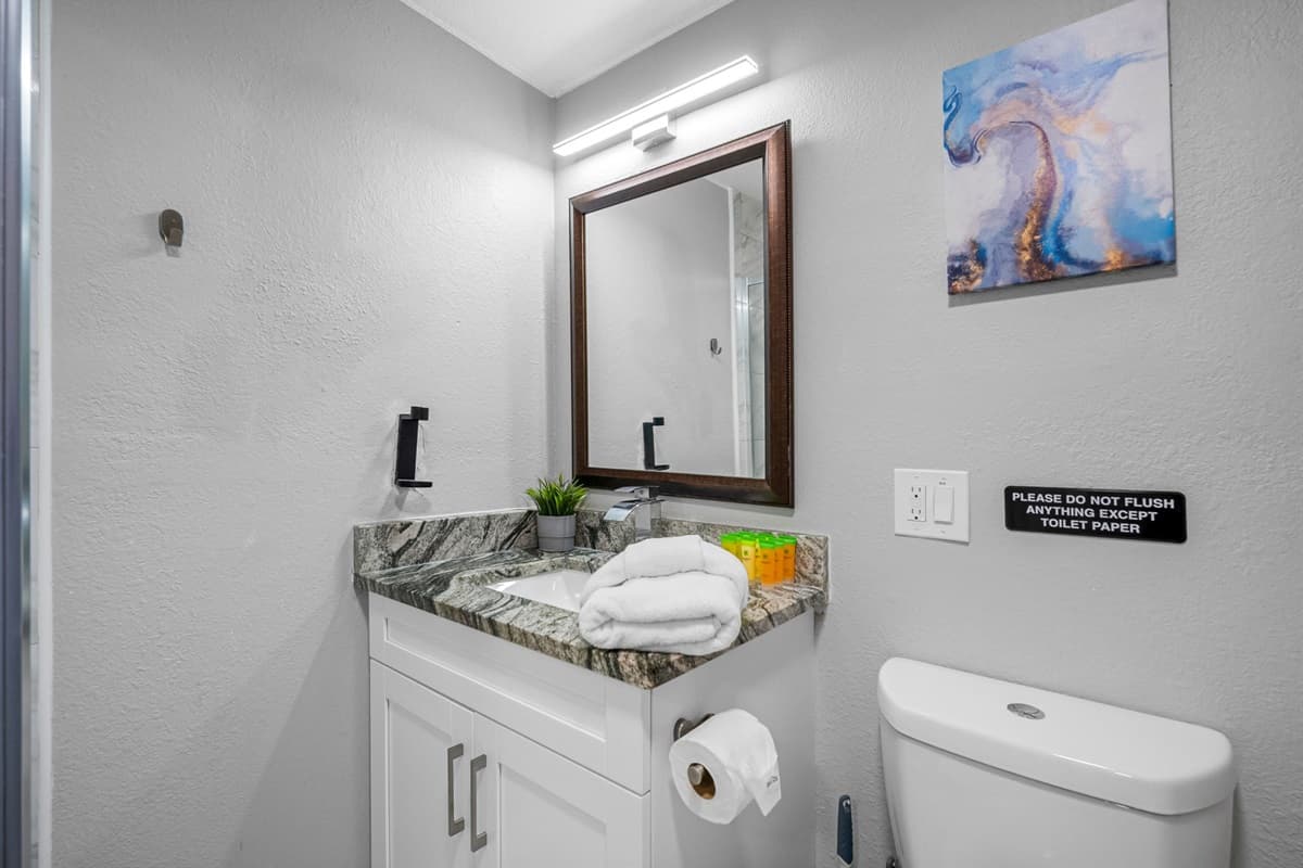 Every detail—from the sleek faucet to the stone countertop—adds a touch of modern charm.