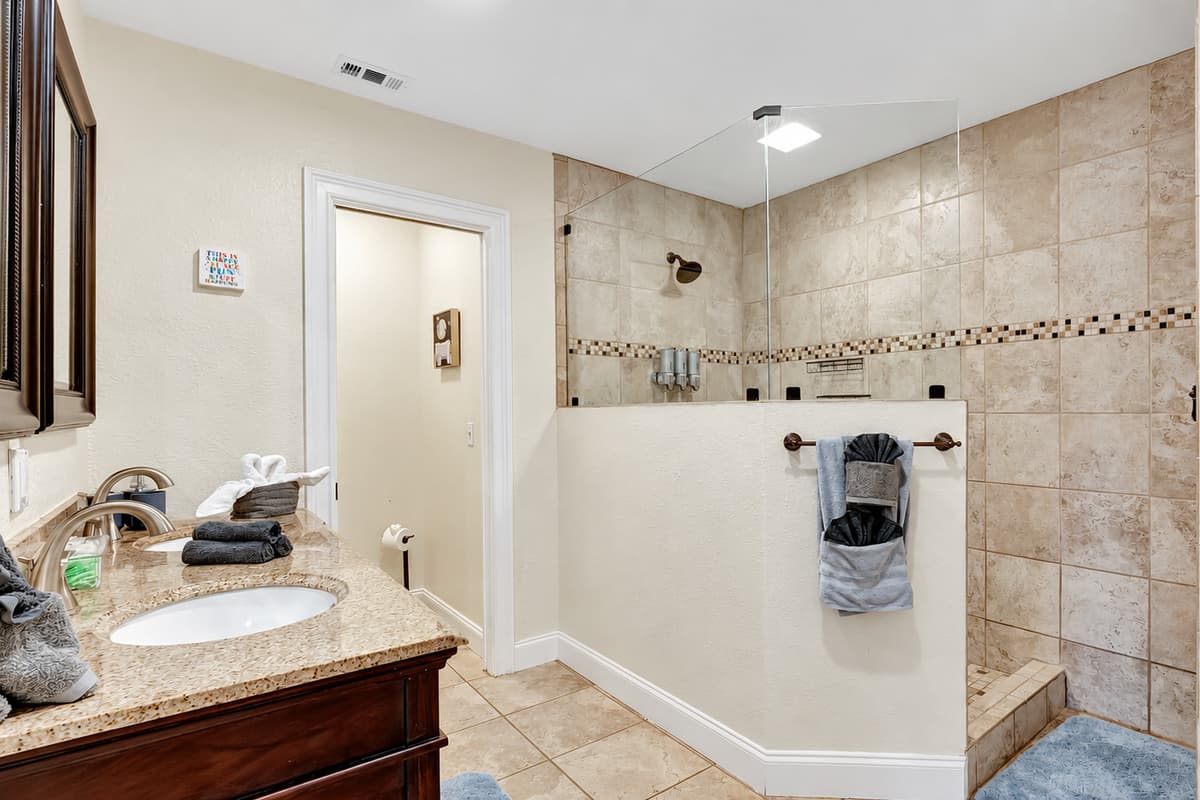 Step into a realm of refined tranquility and elevated indulgence with this stylish and welcoming bathing space.