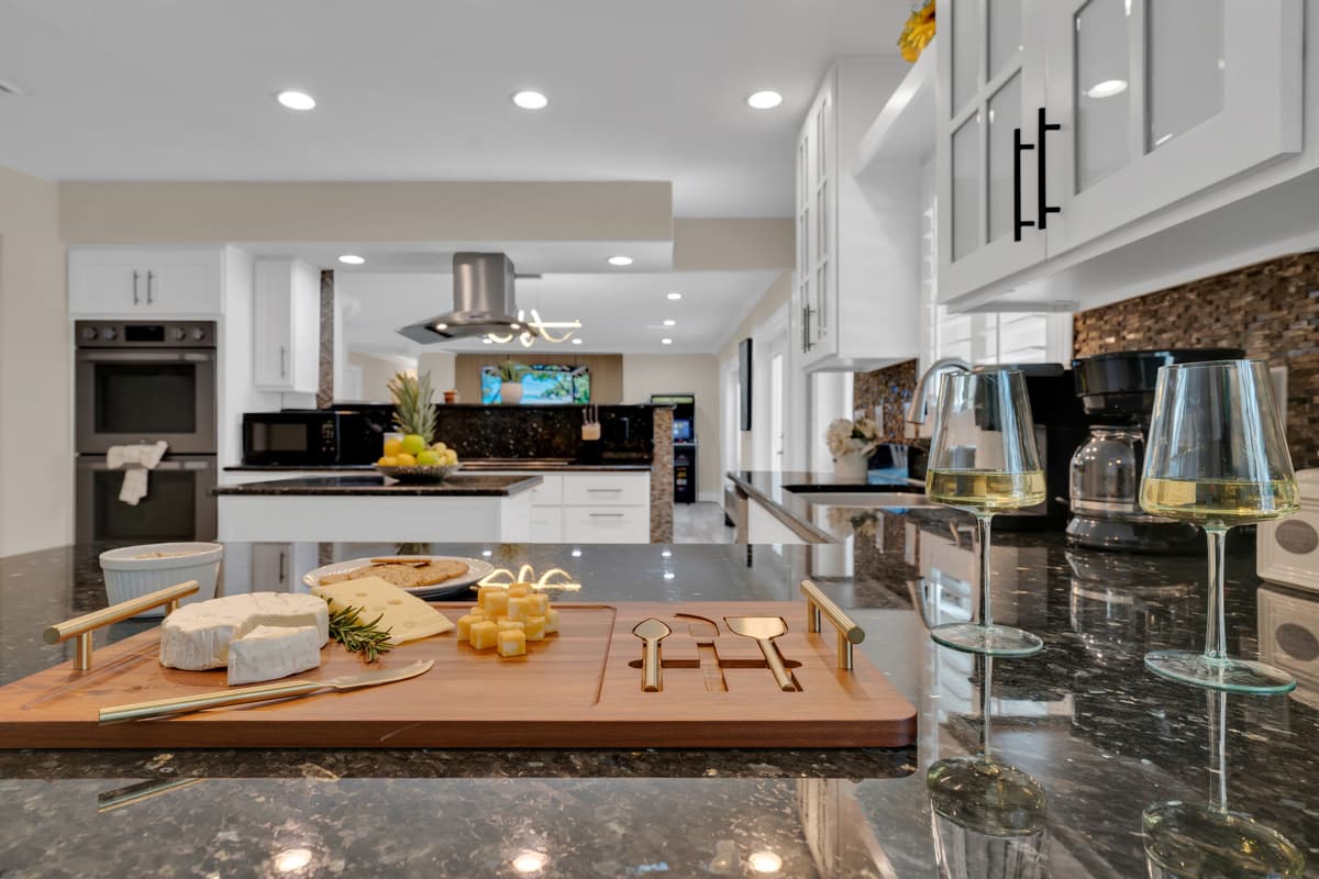 A wine and cheese spread staged on the island shows this chef's kitchen is as ready for entertaining as it is for everyday meals
