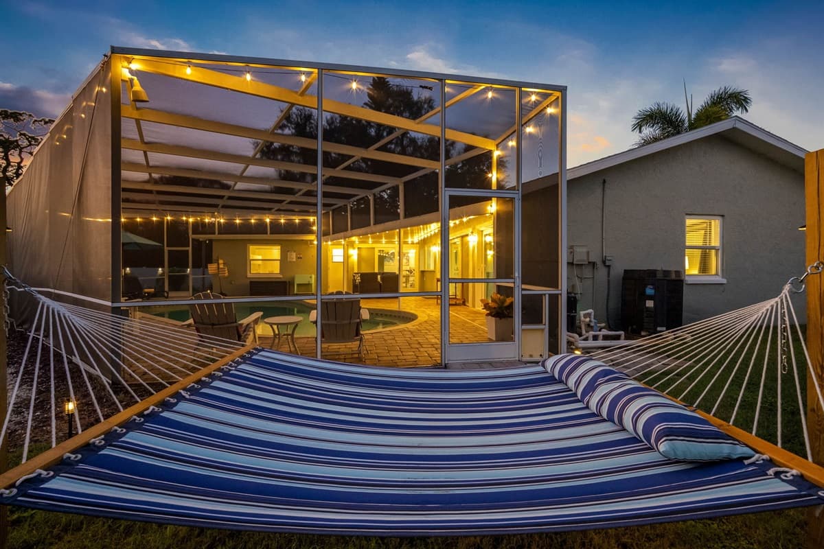 Whether you're enjoying a sunset from the hammock, roasting marshmallows by the firepit, or playing backyard games, this outdoor space was designed for both comfort and entertainment.