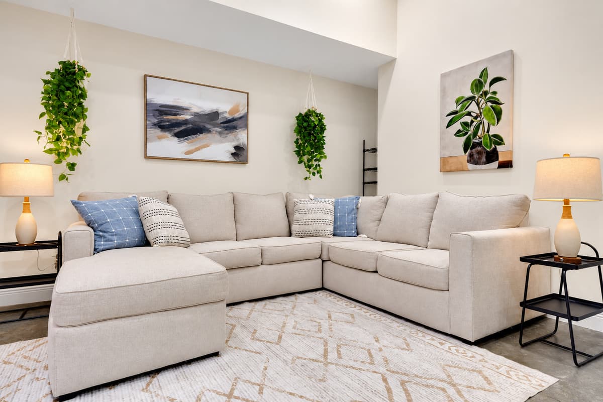 Quiet corner, cold air, nobody looking for you. A full sectional and a lamp in the second living area — the retreat that makes an seven-bedroom stay feel like your own place, not a shared one.