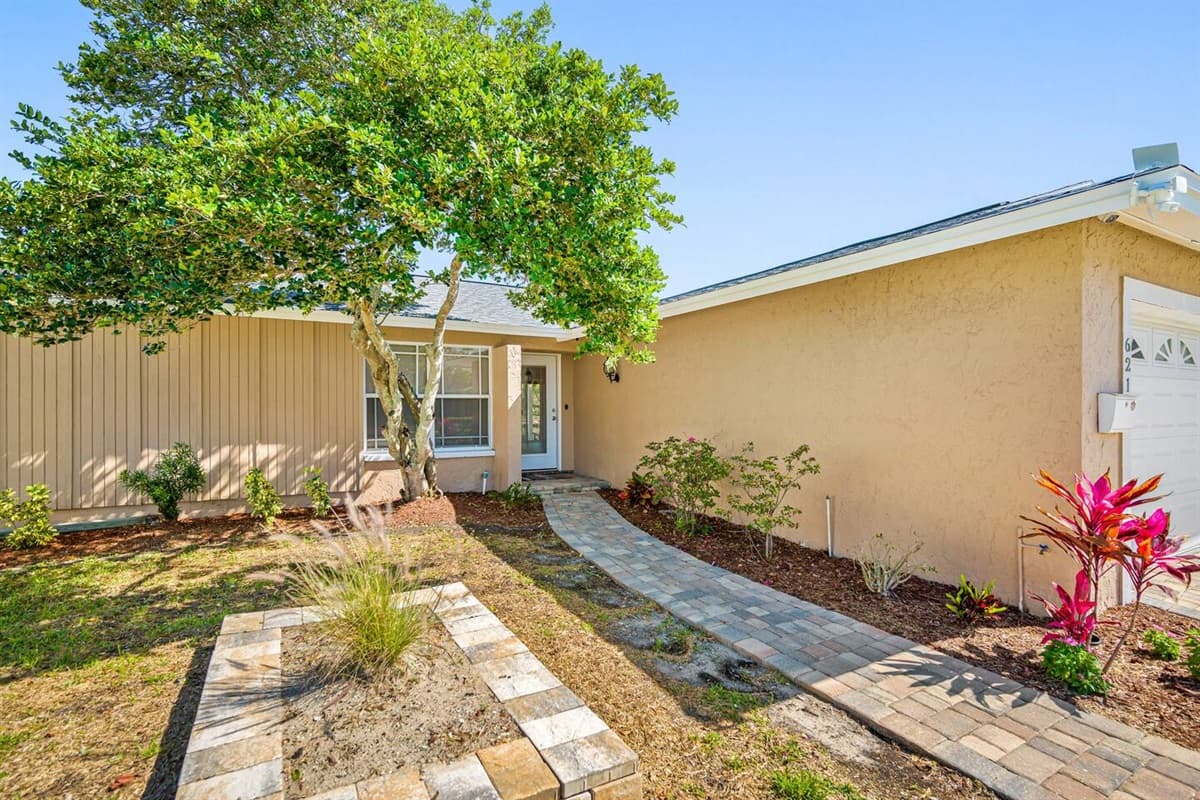 Beautifully maintained entryway of the property that has various beautiful plants on the side and a nice tree. Feel at home and relaxed while on your vacation! If you appreciate things like these, send us a message now!