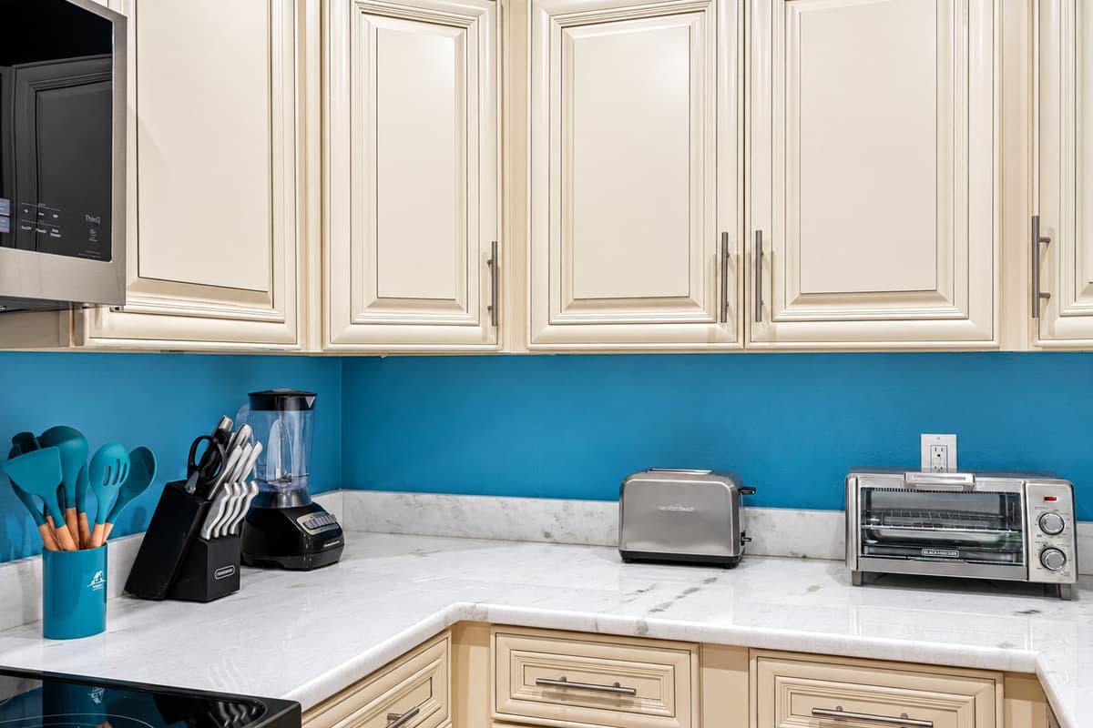 Adding a burst of personality to the space are the vibrant blue painted walls. The hue evokes a sense of tranquility and serenity, providing a visually refreshing backdrop as you prepare delectable meals.