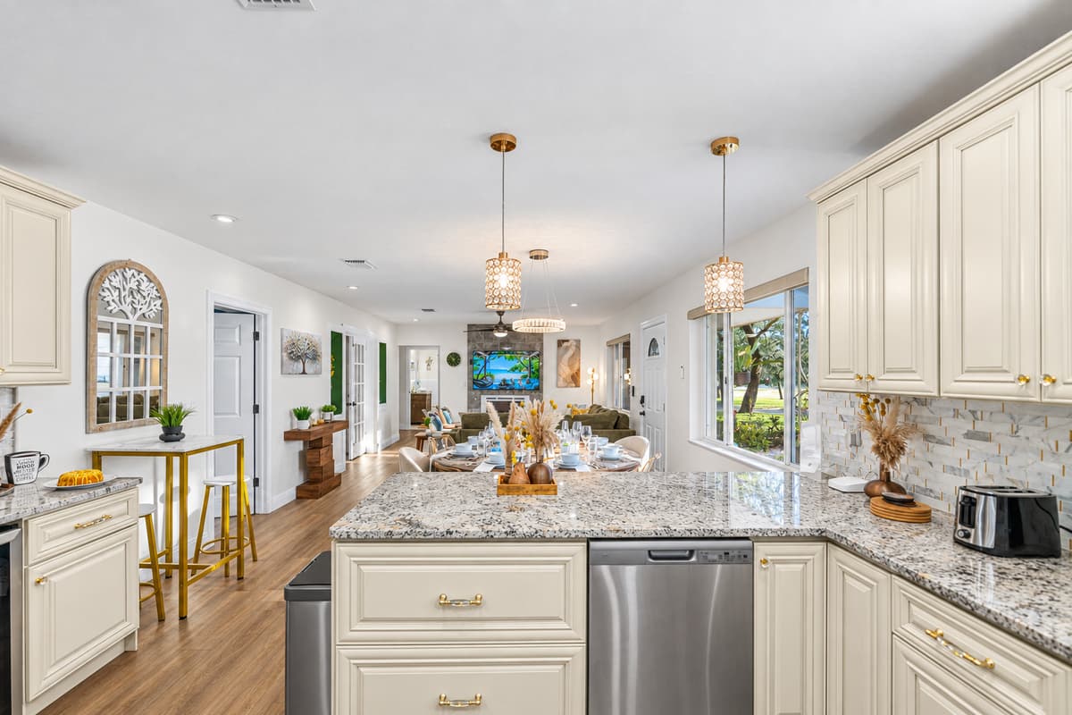 A bright, chef-inspired kitchen featuring elegant cabinetry, granite countertops, and modern appliances—perfect for cooking, gathering, and entertaining.