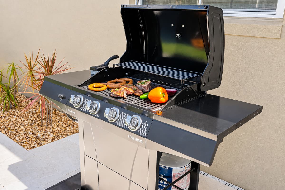 Relax, grill, and dine al fresco in this outdoor oasis featuring a sparkling heated pool and cozy dining area.