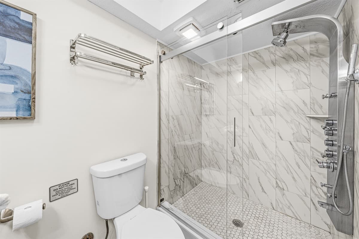 Elegant bathroom with a spacious vanity and beautifully tiled walk-in shower.