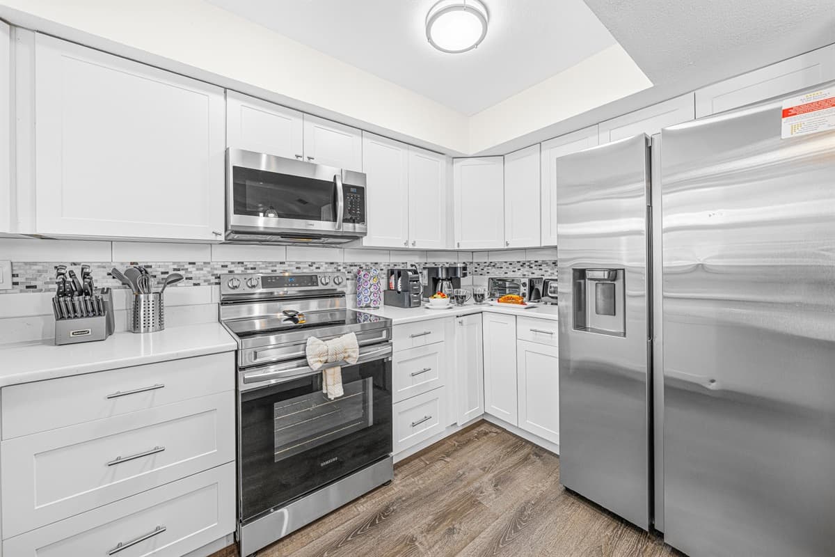 Cook with ease in the well-stocked kitchen with modern appliances and ample storage.