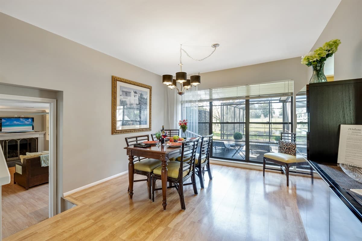 As you gather around the table, bask in the warmth of the sun's gentle rays cascading through the expansive window.