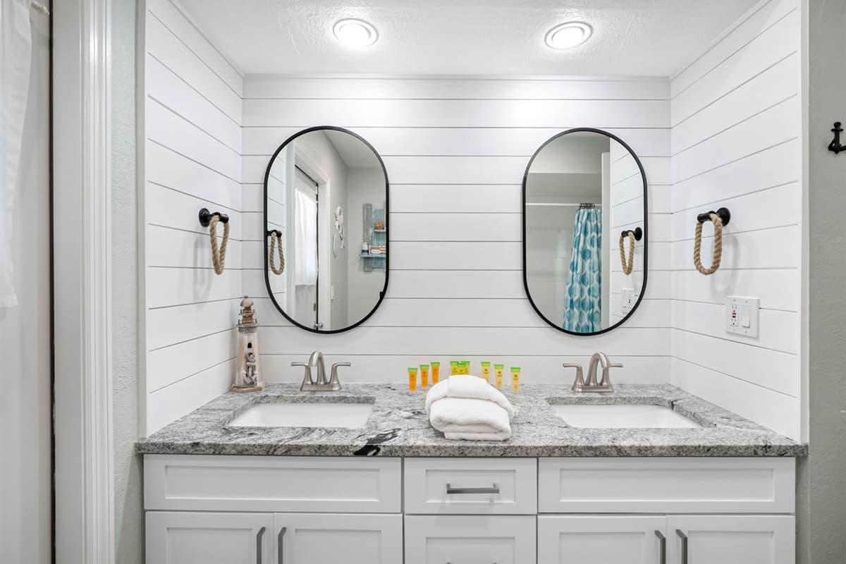 Enjoy the convenience of double vanities, a large walk-in shower, and elegant coastal-inspired details.