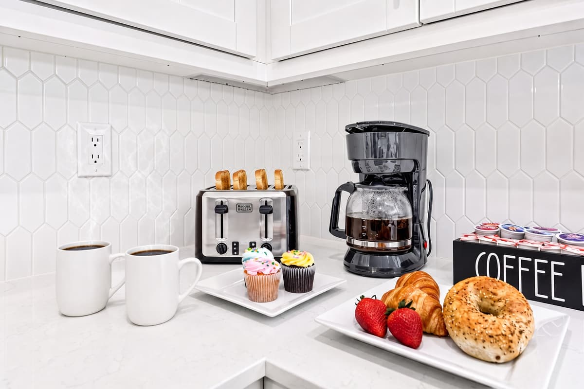 Your personal coffee bar awaits — complete with a coffee maker, toaster, mugs, and K-cup pods. No need to leave for your morning fix.