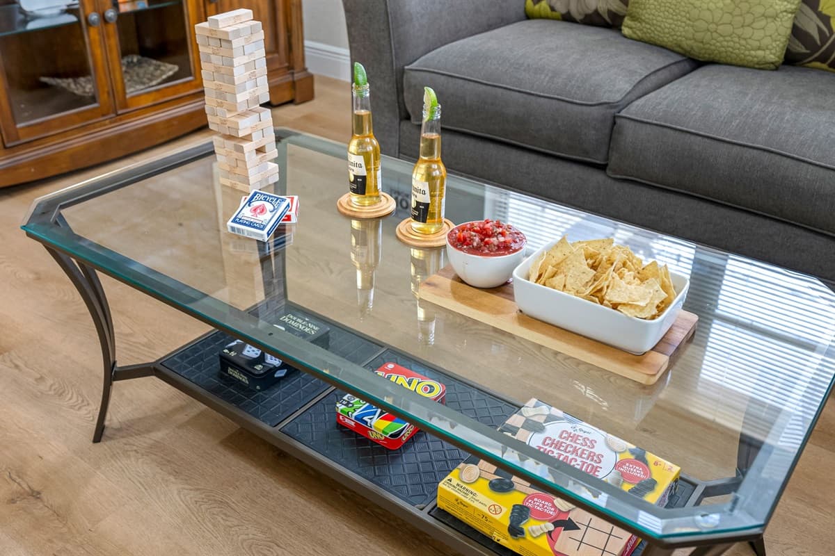 This thoughtfully styled coffee table scene invites guests to kick back, connect, and enjoy a little friendly competition—all from the comfort of your cozy living room.