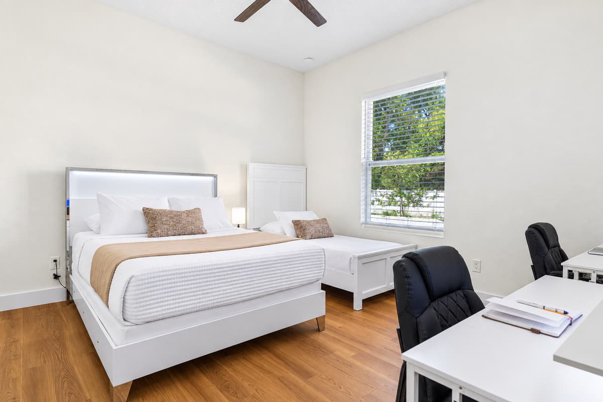 Comfortable bedroom with natural light and minimalist design for a restful stay.
