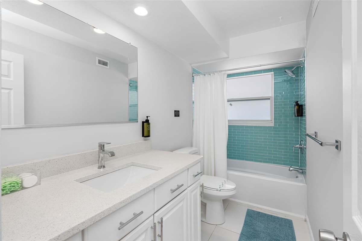 This well-appointed bathroom features both a tub and a shower, offering flexibility and comfort for your personal care routine.