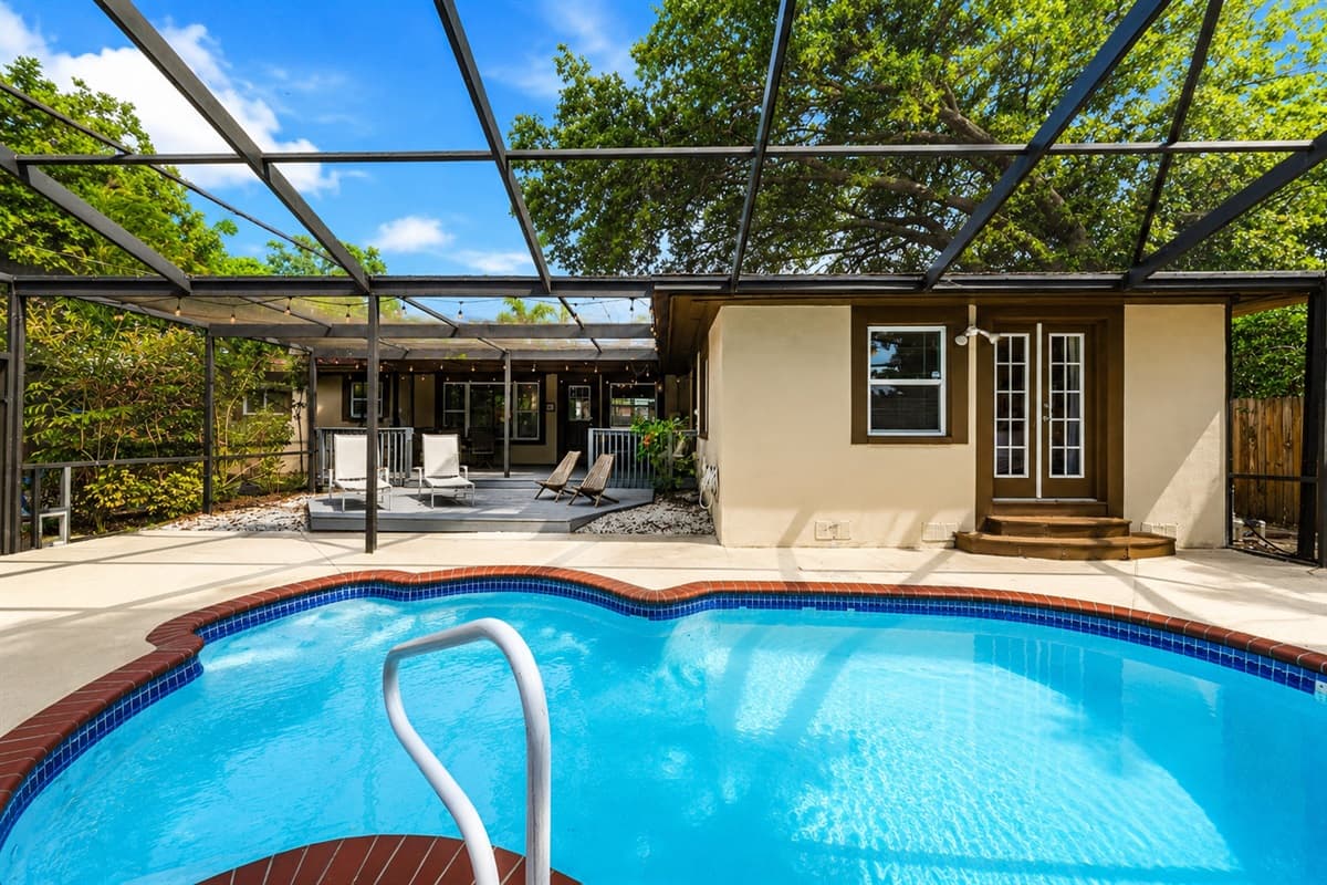 Beautiful backyard pool with relaxing views of the covered patio and outdoor entertainment area.