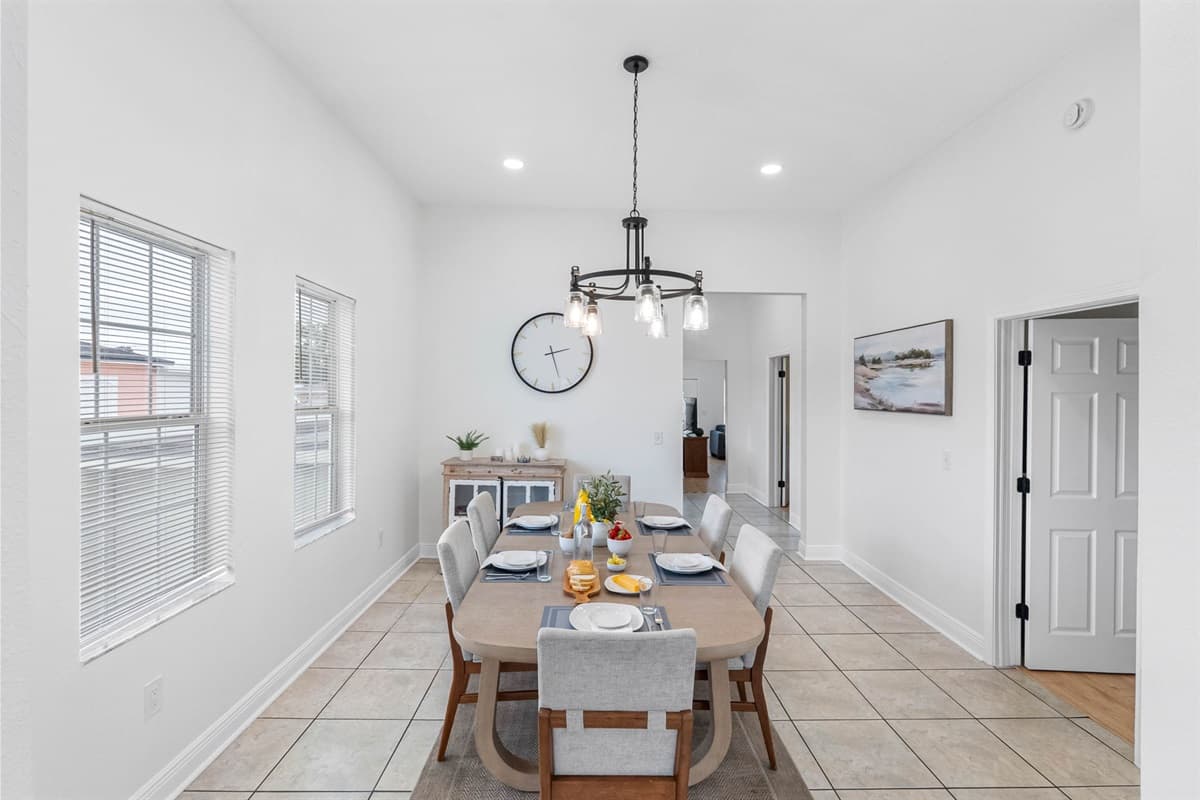 The dining space is thoughtfully arranged with ample seating, contemporary lighting, and a welcoming layout.