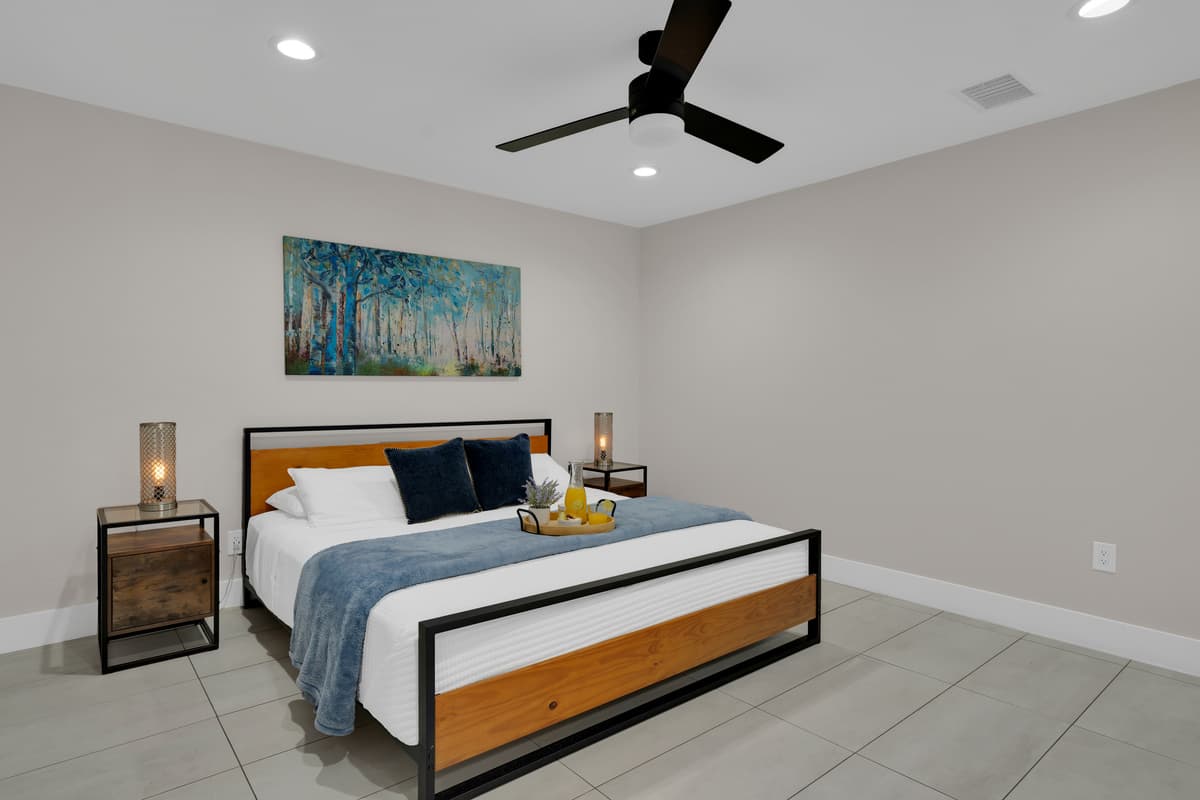 Clean lines, warm wood, a ceiling fan doing slow work overhead, this is the room where jet lag stops mattering.