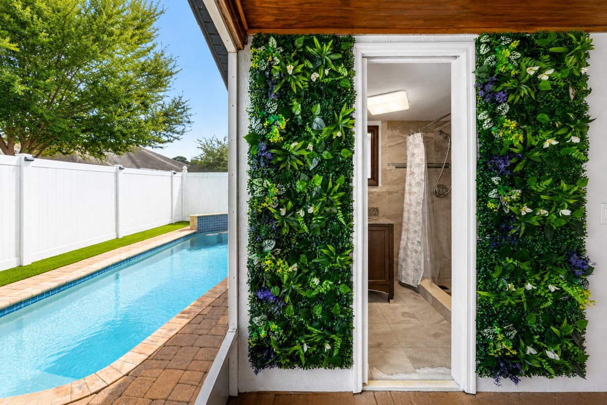 Convenient outdoor bathroom located just steps from the pool and patio area, offering easy access for guests enjoying the backyard amenities.