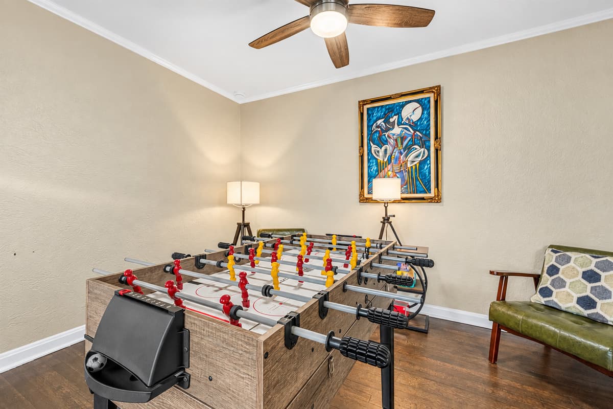 Dedicated game area with foosball table and comfortable seating for game nights.