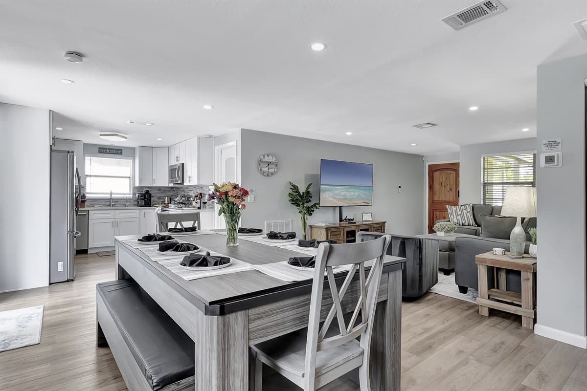 A spacious dining table for 8 takes center stage, ready to host memorable meals and gatherings.