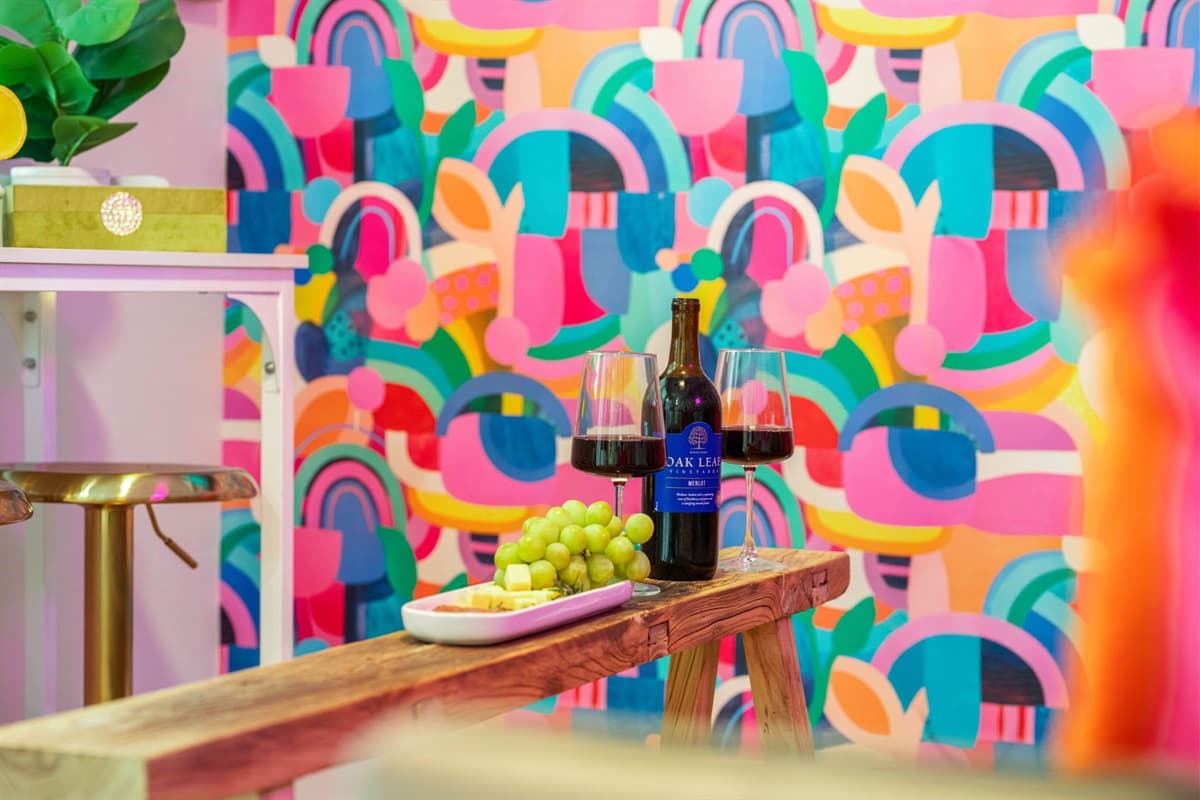 Playful pops of color are thoughtfully placed around the room, adding energy and warmth to the inviting space.