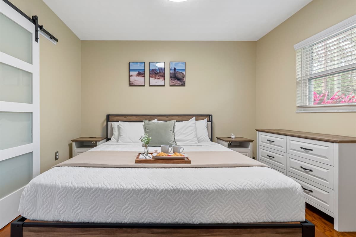 Spacious king bedroom with modern touches and a warm, inviting feel.