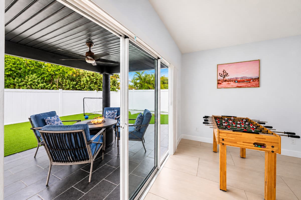 Open the doors and the house doubles in size. Covered patio, ceiling fans, lounge seating and foosball one step away. Indoors and out blend into one long afternoon. Shade when you want it, sun when you do not.