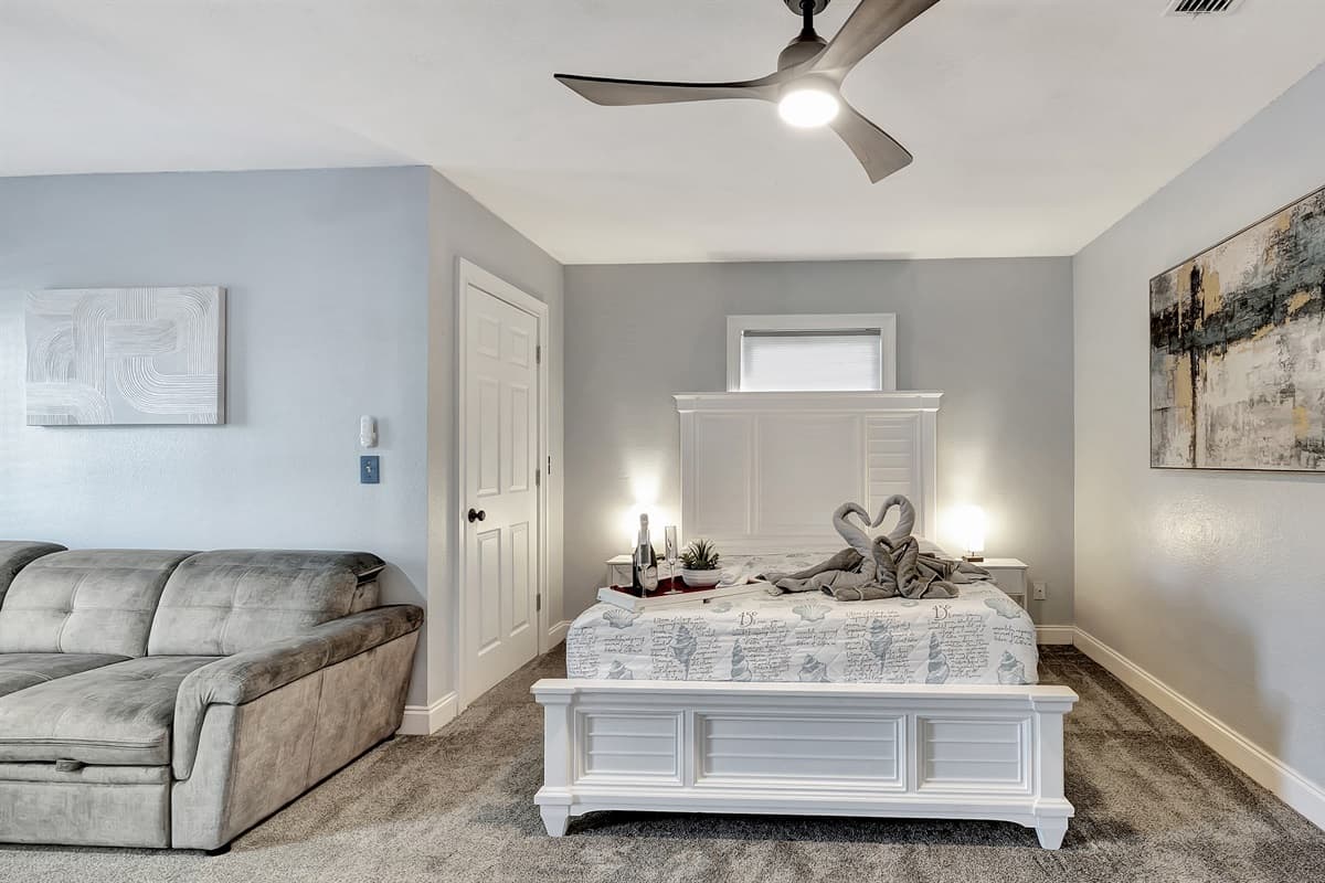 Indulge in pure luxury as you unwind in our spacious bedroom, where a sumptuous king-size bed awaits.
