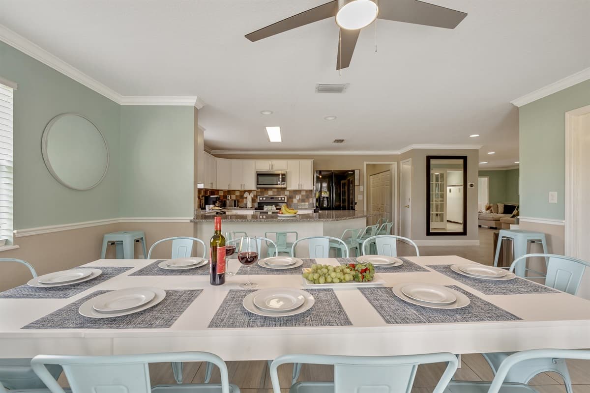 Gather around the inviting dining table, surrounded by a collection of comfortable chairs.