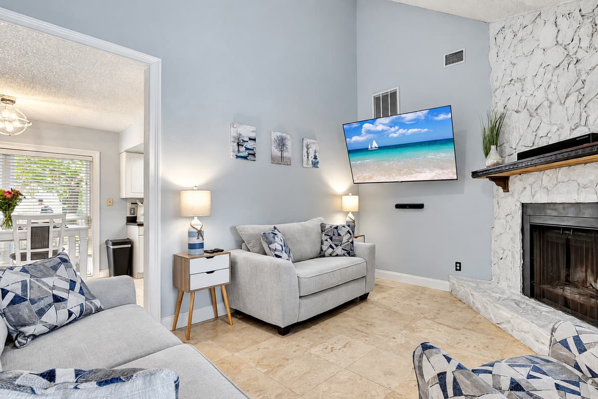 The warm glow of the fireplace sets the perfect ambiance for cozy evenings, making this space a haven for unwinding and creating cherished memories.