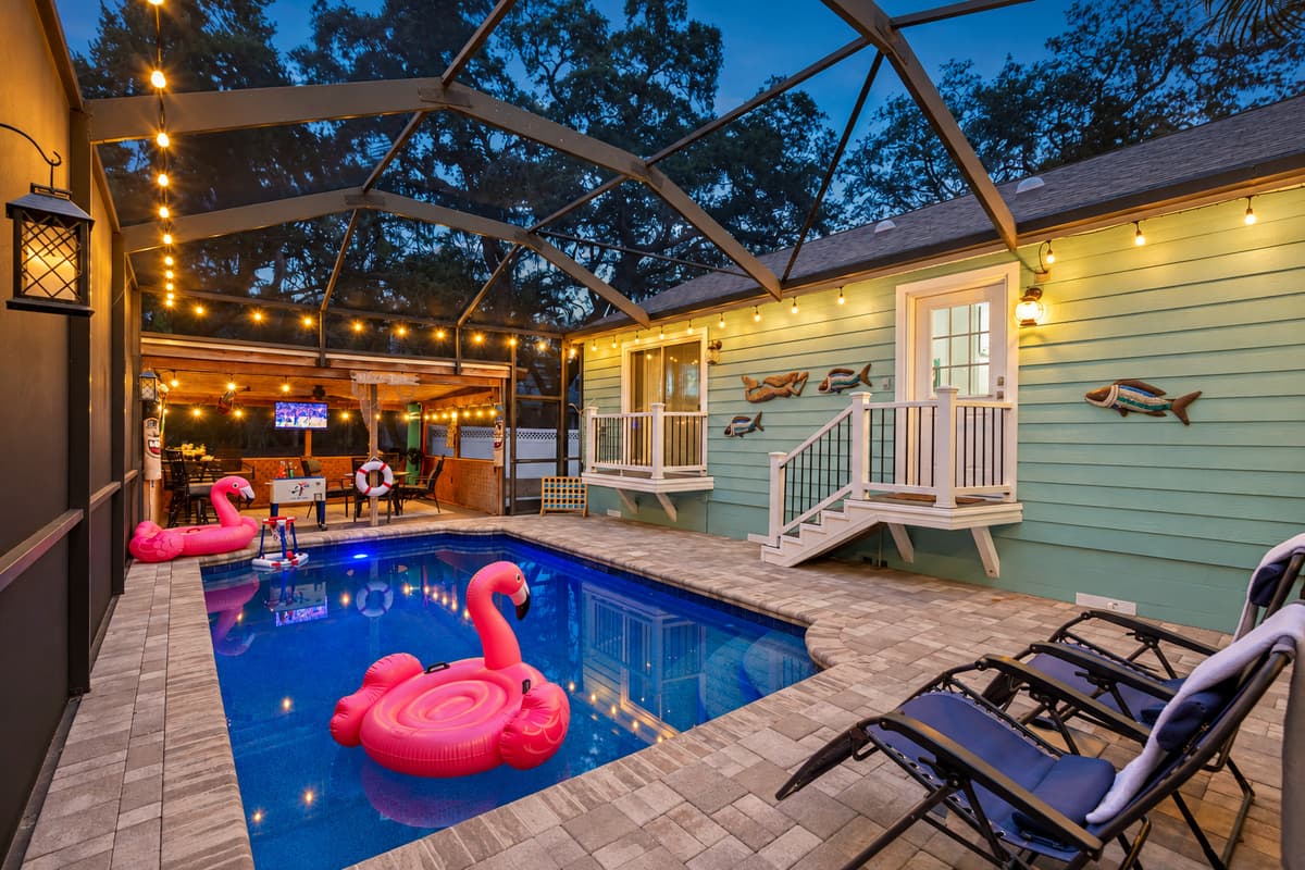 This pool area features a covered tiki-themed lounge, outdoor TV, and fun décor, making it the ultimate hangout spot.
