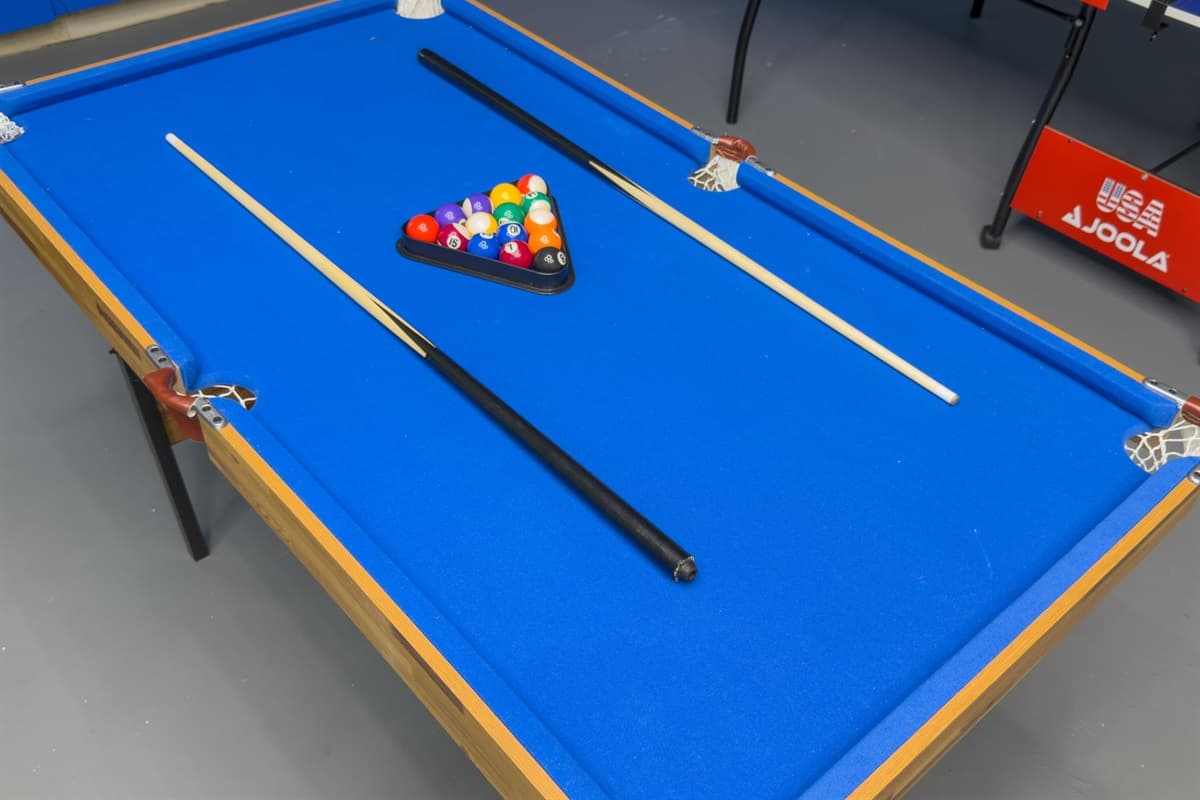 A modern, well-equipped game room featuring stylish lighting and entertainment for everyone to enjoy.
