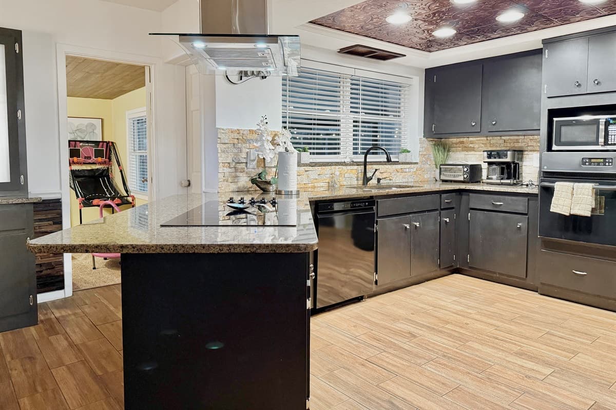 Spacious, modern kitchen featuring sleek cabinetry and ample counter space.