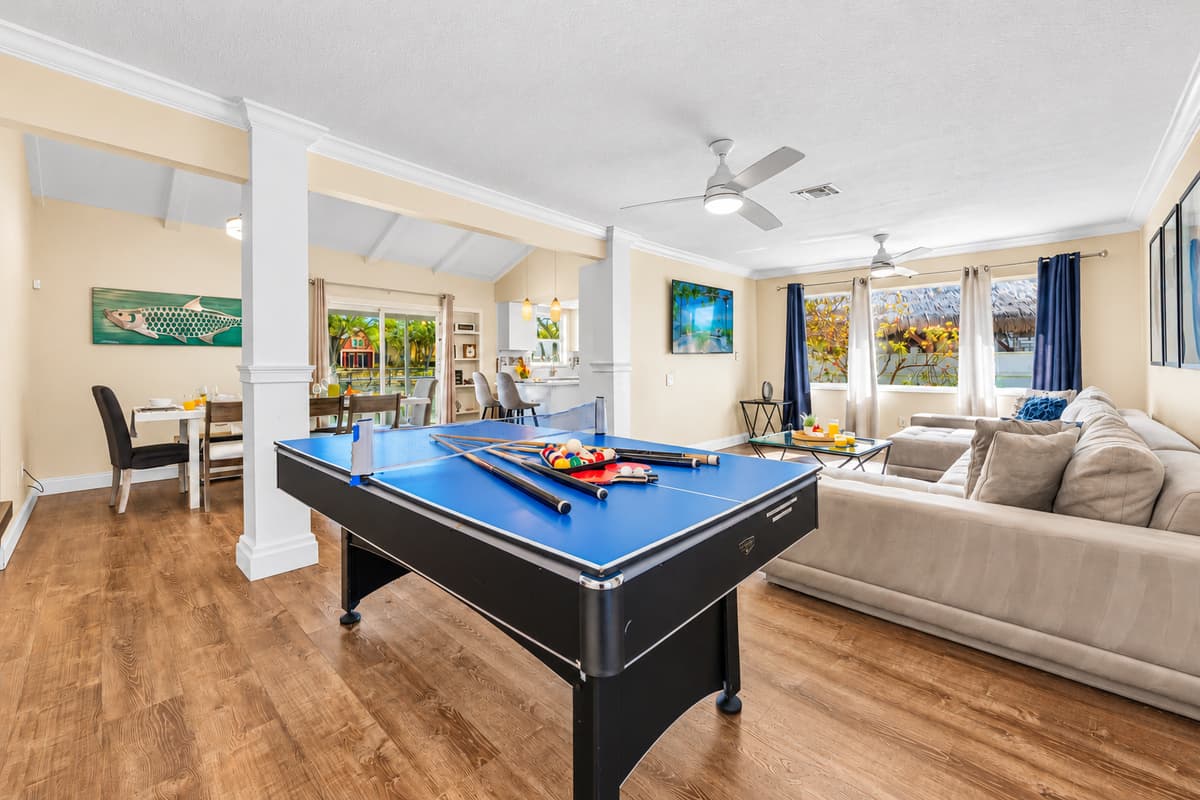Open floor plan connects the game room, dining area, and living room for easy gathering.