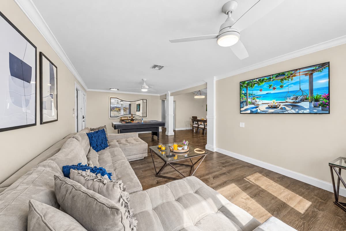 Open-concept living area featuring comfortable seating, a Smart TV, and plenty of natural light.
