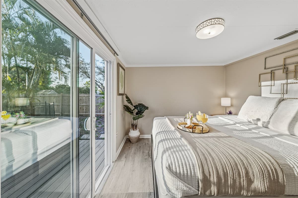 Sunlit bedroom with direct outdoor access and a peaceful ambiance.