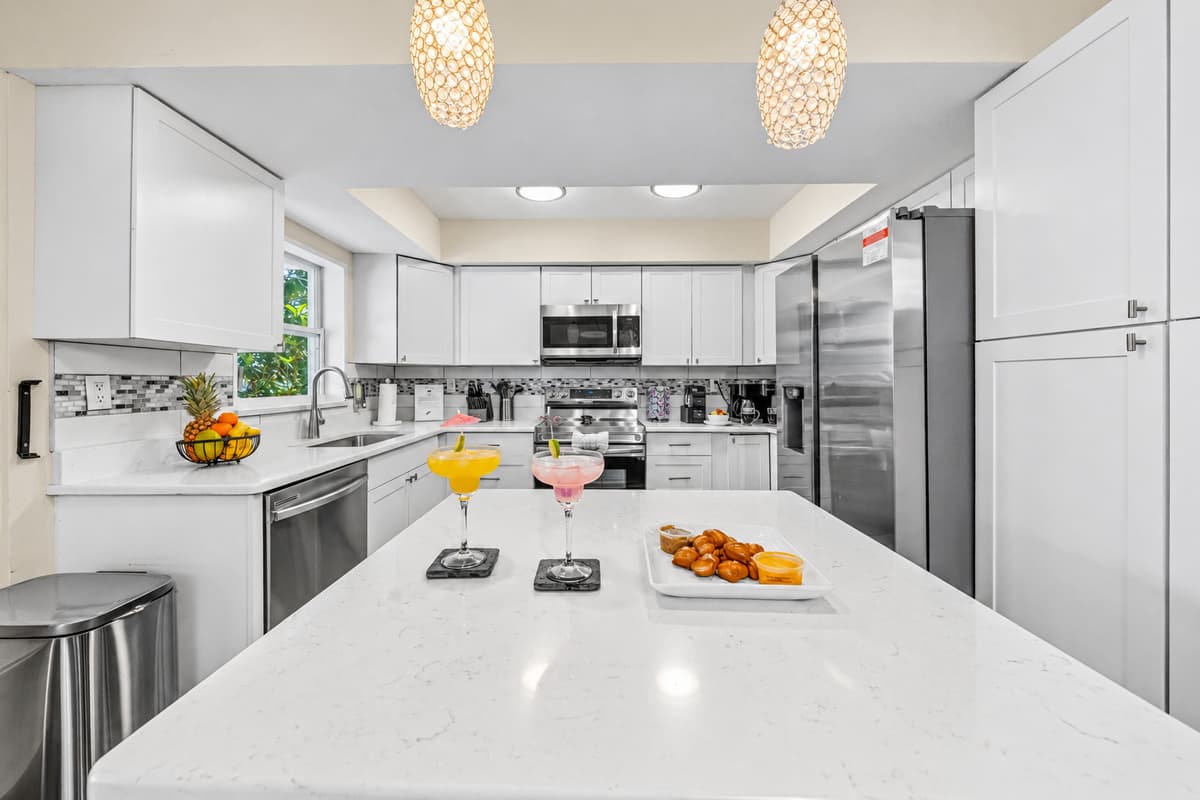 Large kitchen island provides the perfect gathering spot for meals, drinks, and conversation.