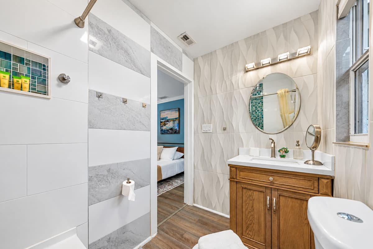 Enjoy a beautifully updated bathroom with a sleek vanity, contemporary fixtures, and plenty of light.
