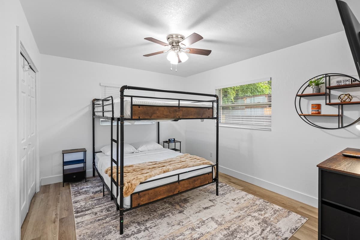 This modern bunk room offers space-saving design with a touch of industrial flair—equipped with soft bedding, ample lighting, and relaxing vibes.