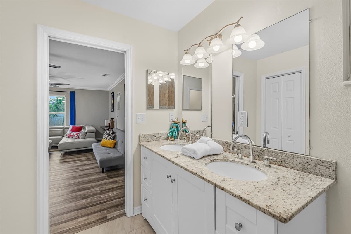 Bright bathroom with large vanity and easy access to adjacent living spaces.