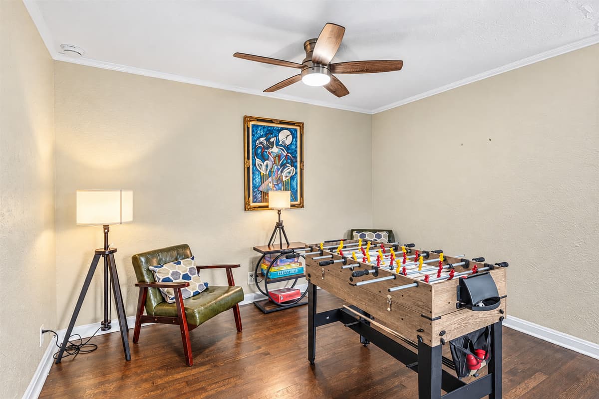 Fun-filled game room featuring a foosball table and cozy seating for friendly competition.